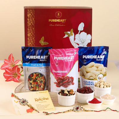 PUREHEART Rakhi Gift Hamper- Natural Cashews, Fruit & Nut Nutmix and Cranberries(80g, each) with Floral Rakhi for Brother, Gift Card, Pooja Rice, Kumkum - Crunchy Dry Fruits and Nuts