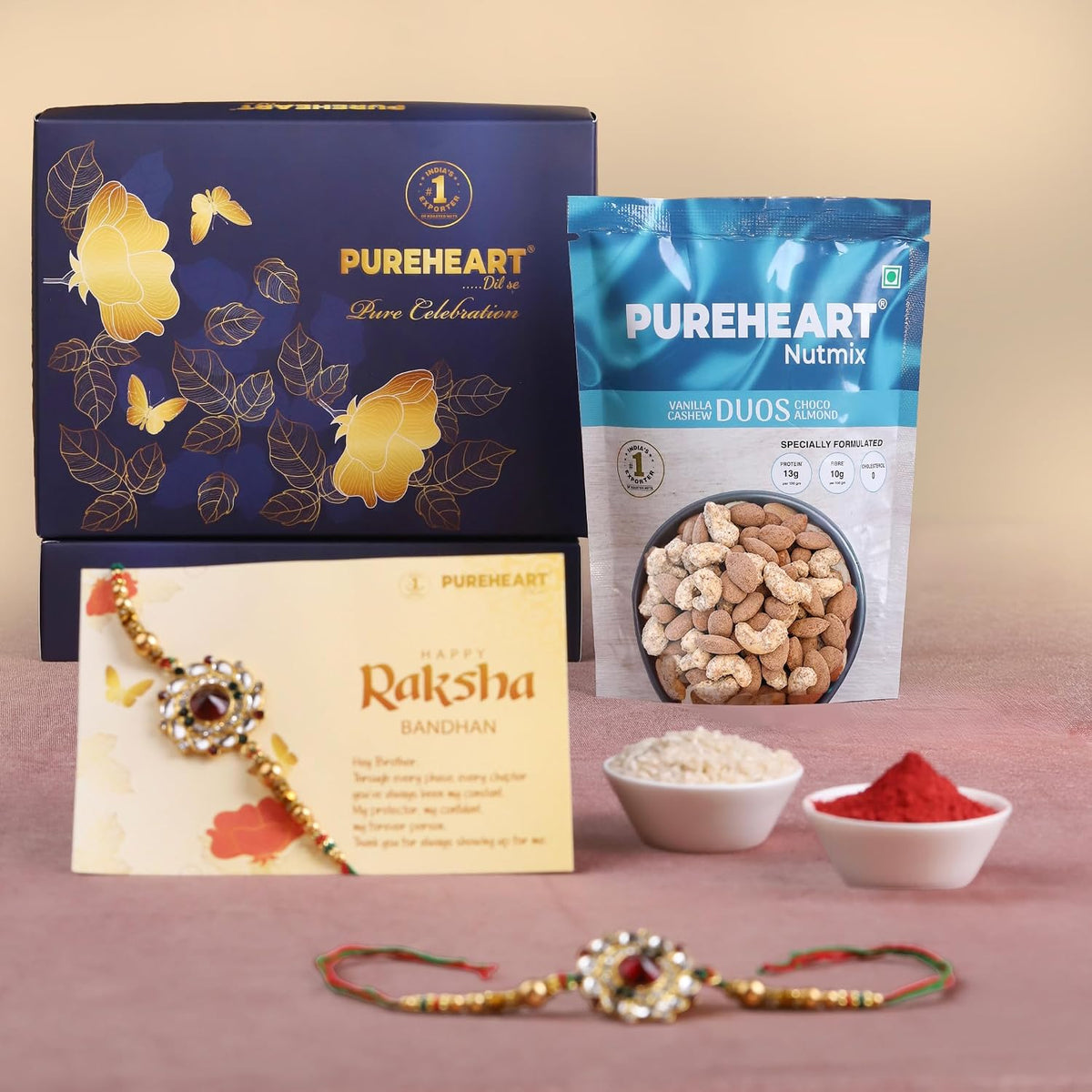 PUREHEART Rakhi Gift Hamper- Vanilla Cashew & Choco Almonds (80g) with Chocolate and Floral Rakhi for Brother, Gift Card, Pooja Rice, Kumkum - Dry Fruits and Nuts Gift