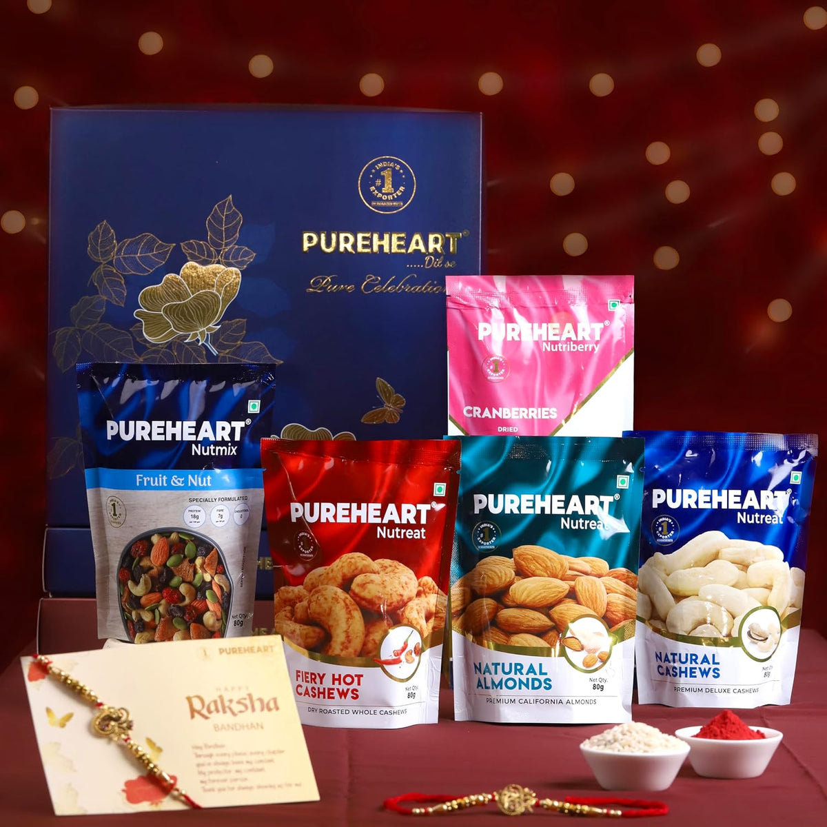 PUREHEART Rakhi Gift Hamper - Natural and Fieryhot Cashews, Almonds, Fruit & Nut Nutmix, Cranberries (80 g, each), Dark Chocolate with Rakhi for Brother, Card, Rice, Kumkum
