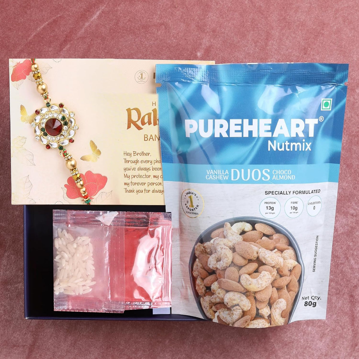 PUREHEART Rakhi Gift Hamper- Vanilla Cashew & Choco Almonds (80g) with Chocolate and Floral Rakhi for Brother, Gift Card, Pooja Rice, Kumkum - Dry Fruits and Nuts Gift