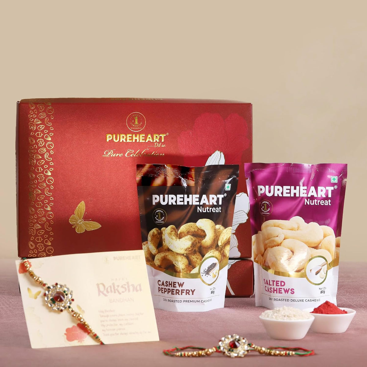 PUREHEART Rakhi Gift Hamper - Salted Cashews, Pepperfry Cashews (80g, each) with Floral Rakhi for Brother, Gift Card, Pooja Rice, Kumkum