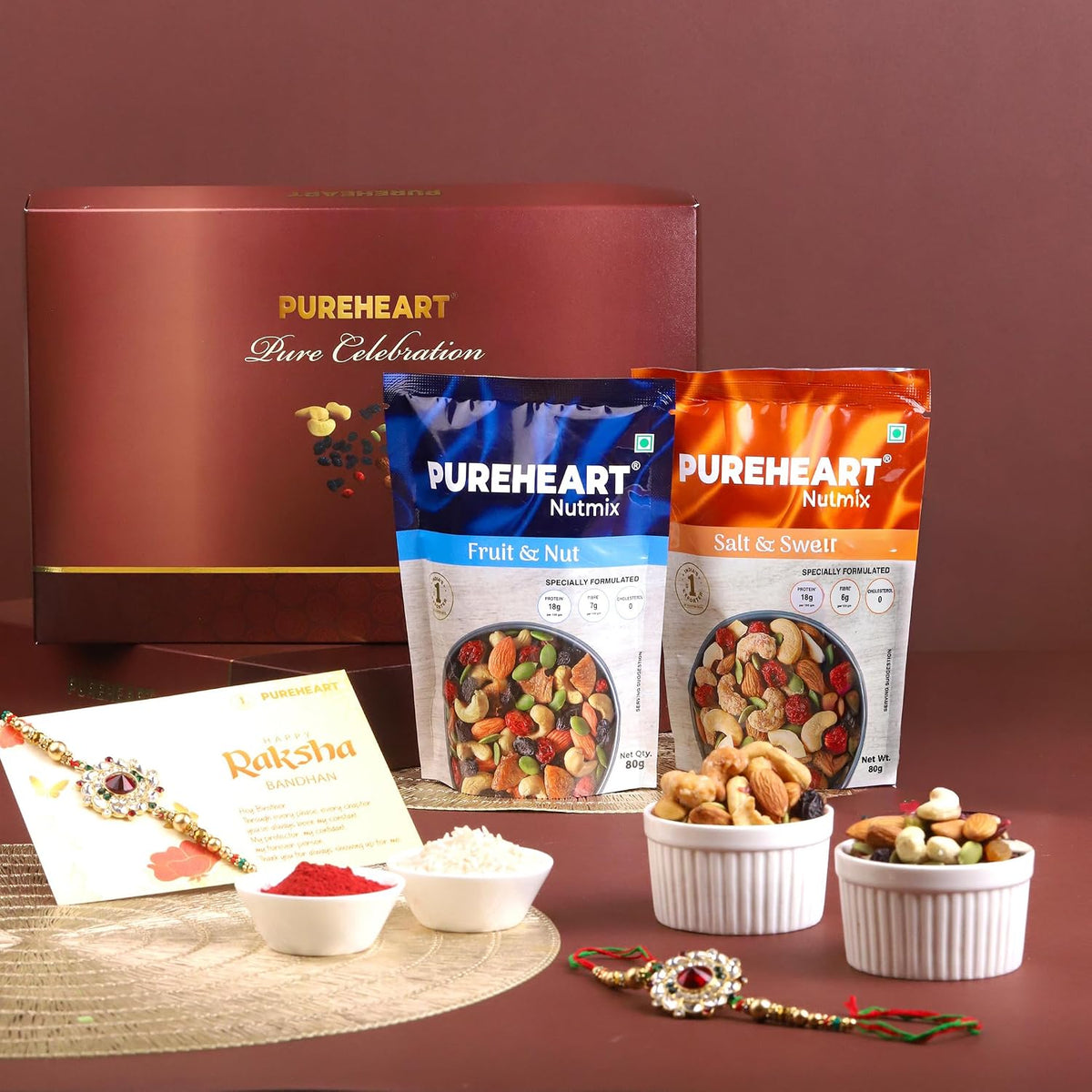 PUREHEART Rakhi Gift Hamper Combo of Natural Fruit & Nut Nutmix, Sweet & Salt Nutmix (80 g, each), Dark Chocolate with Floral Rakhi for Brother, Card, Pooja Rice, Kumkum