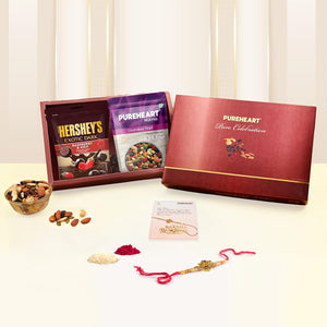 PUREHEART Pure Celebration Rakhi Gift Hamper - Cherokee Trail Mix (80 g) & Hershey's Kisses Chocolate with Beautiful Ganpati Rakhi for Brother, Gift Card, Pooja Rice, Kumkum, Premium Dry Fruits Gift